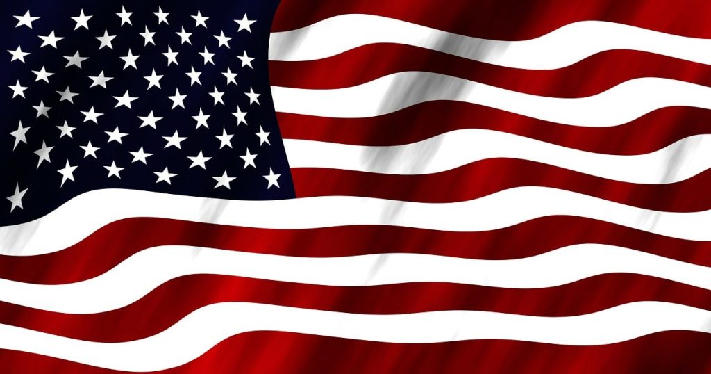 An American flag with a wavy design, featuring stars on a blue field and red and white stripes.