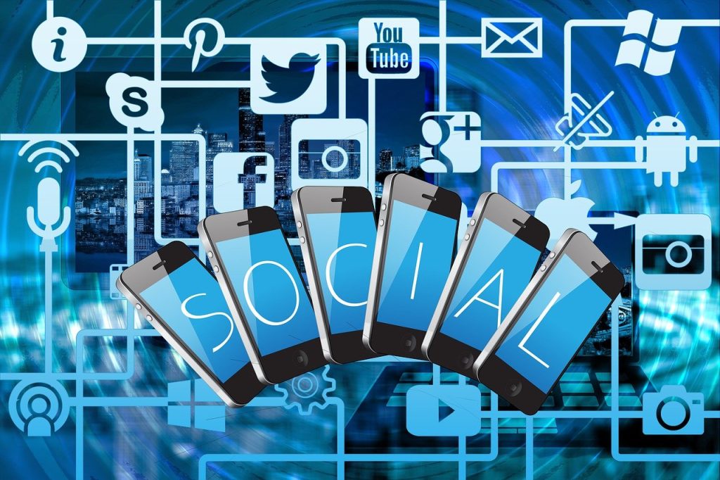 "Illustration of smartphones spelling out the word 'SOCIAL' over a digital background filled with interconnected icons of popular social media and tech platforms such as Facebook, Twitter, Instagram, YouTube, and Android."

