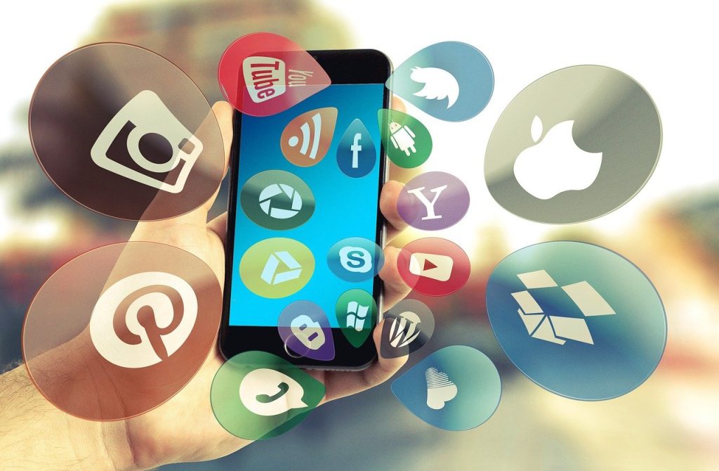 "Smartphone with floating social media and app icons."
