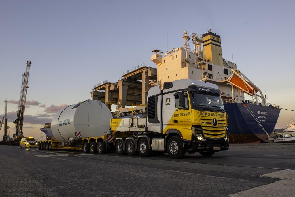 Transport truck in front of a Vessel at Port