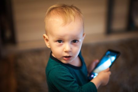 A kid is using cell phone