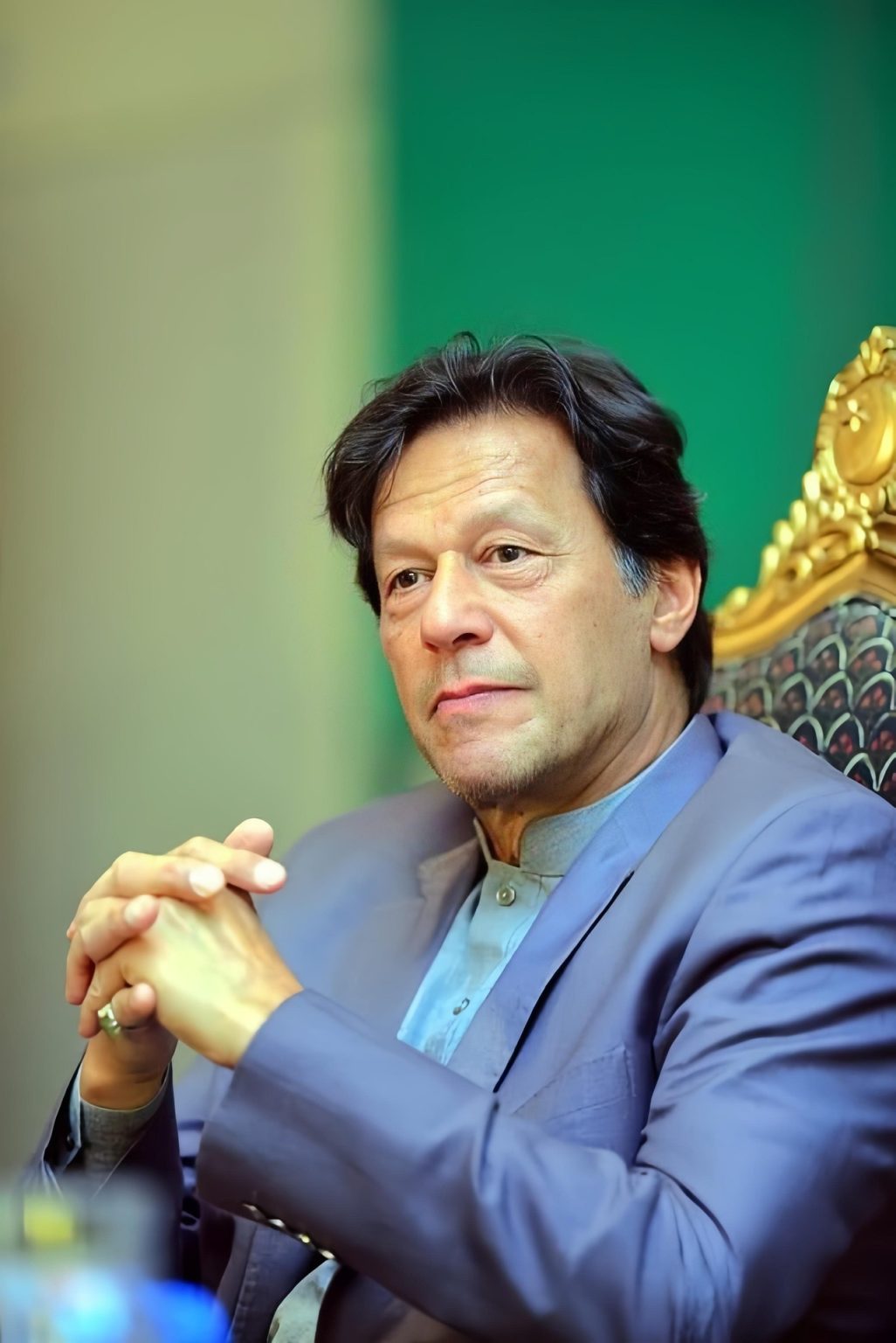 Imran Khan’s Polygraph Refusal May Hurt May 9 Trial Case – Imran Khan seated in a formal setting, wearing a traditional outfit with a serious expression.