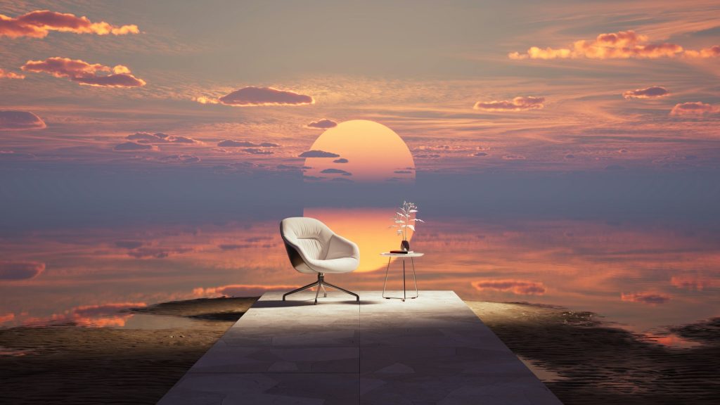 Minimalist chair and table facing a serene sunset, symbolizing digital simplicity and mindful living.