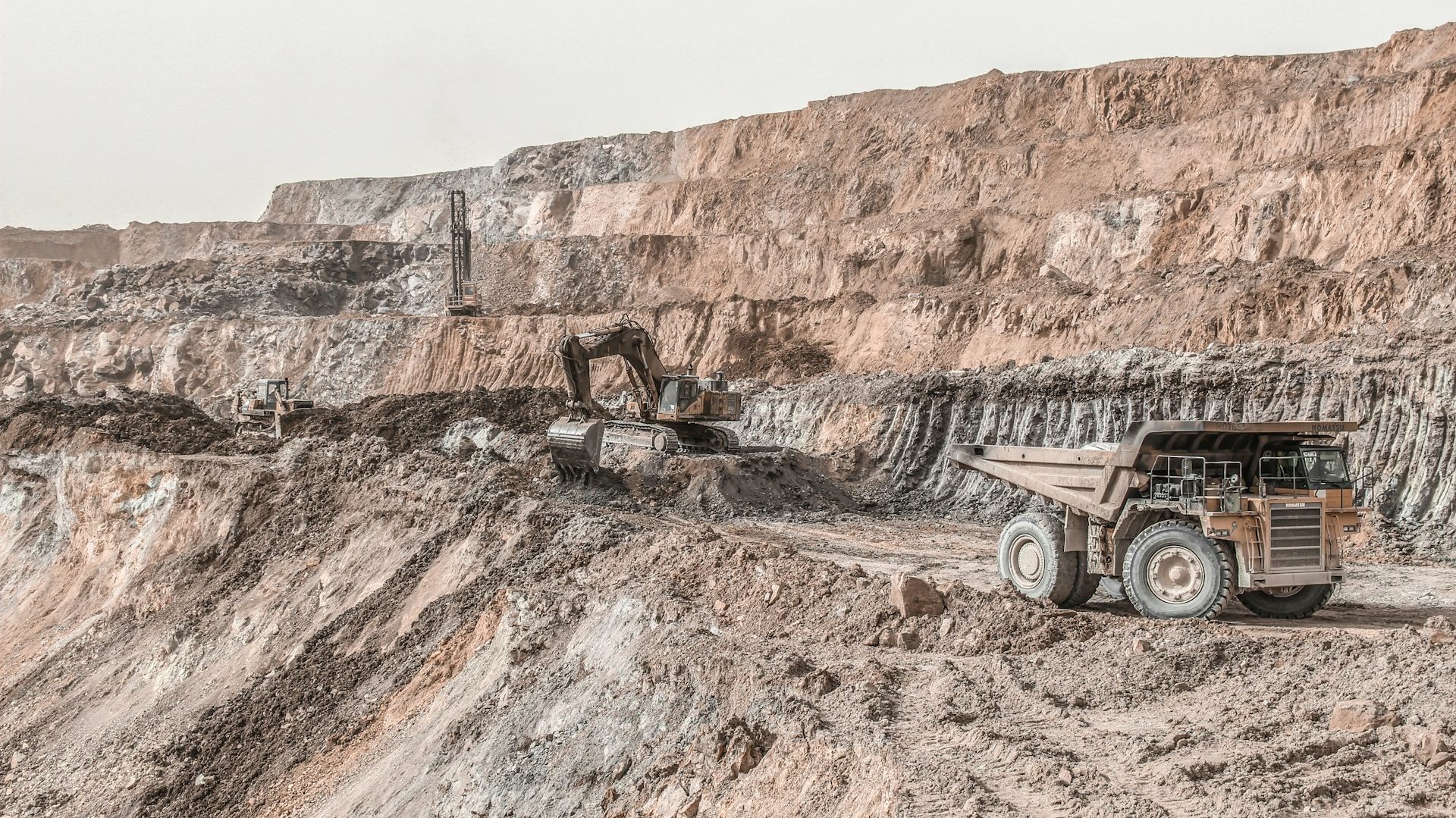 Open-pit copper mine with heavy machinery operating in Balochistan. Scene reflects growing interest in Chinese investment for mineral extraction.