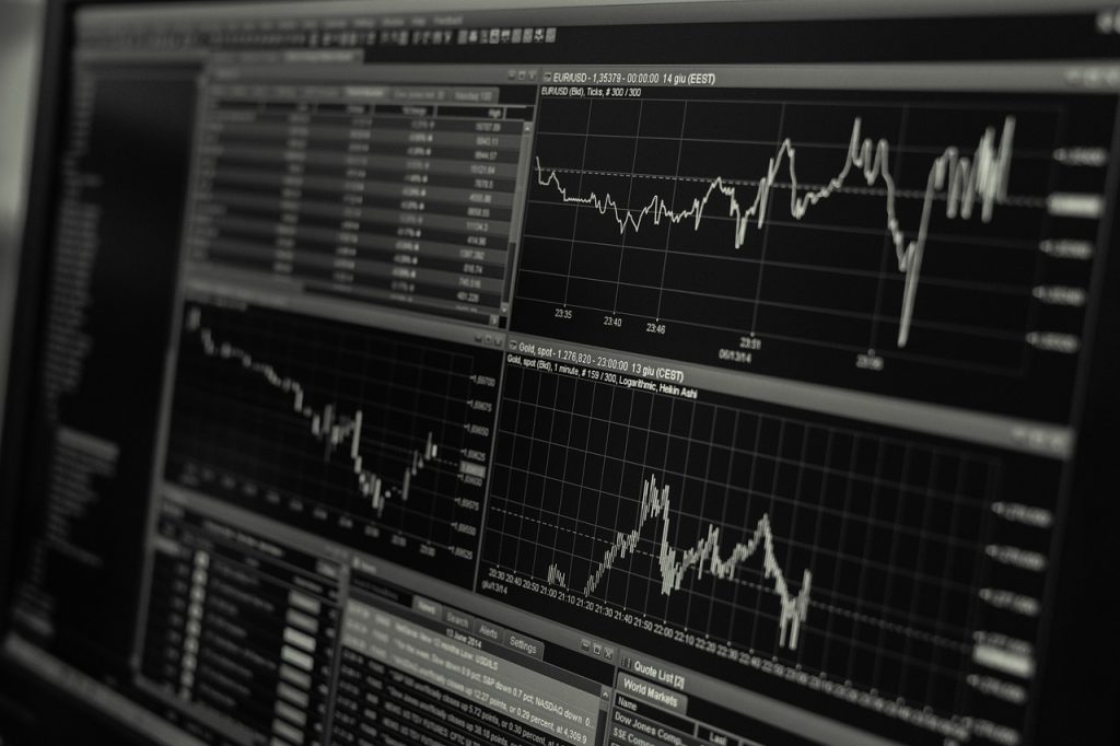 Line graphs showing sharp upward trends on a financial trading screen, reflecting record highs in the Pakistan Stock Exchange following the federal budget announcement.