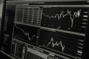 Line graphs showing sharp upward trends on a financial trading screen, reflecting record highs in the Pakistan Stock Exchange following the federal budget announcement.