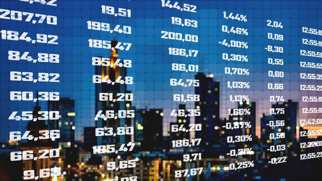 Pakistan Stock Market Surges on Iran-Israel Ceasefire – A digital display of stock prices and percentages with a city skyline blurred in the background, reflecting market activity and investor sentiment.