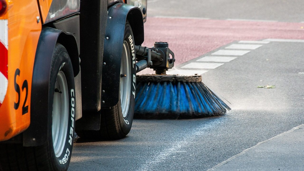 Street cleaning vehicle sweeping the road, illustrating municipal efforts in cleanliness as part of Punjab’s new garbage tax collection initiative