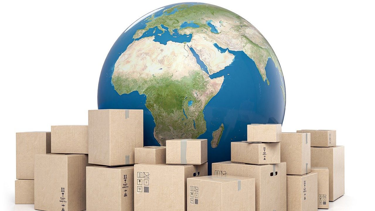 The image shows a globe with Africa and Europe in view, surrounded by cardboard boxes, symbolizing global shipping and international trade.