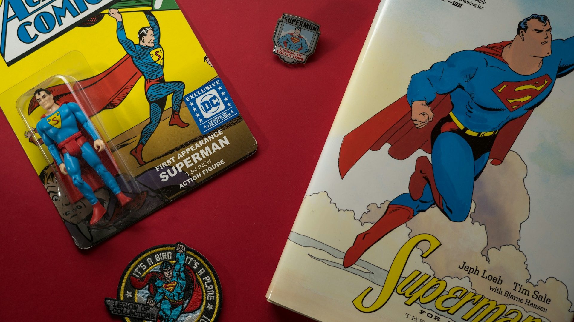 A collection of vintage Superman memorabilia, including an action figure, comic book, and collector’s items, symbolizing Superman's surprise cameos that are pushing the DC Universe forward.