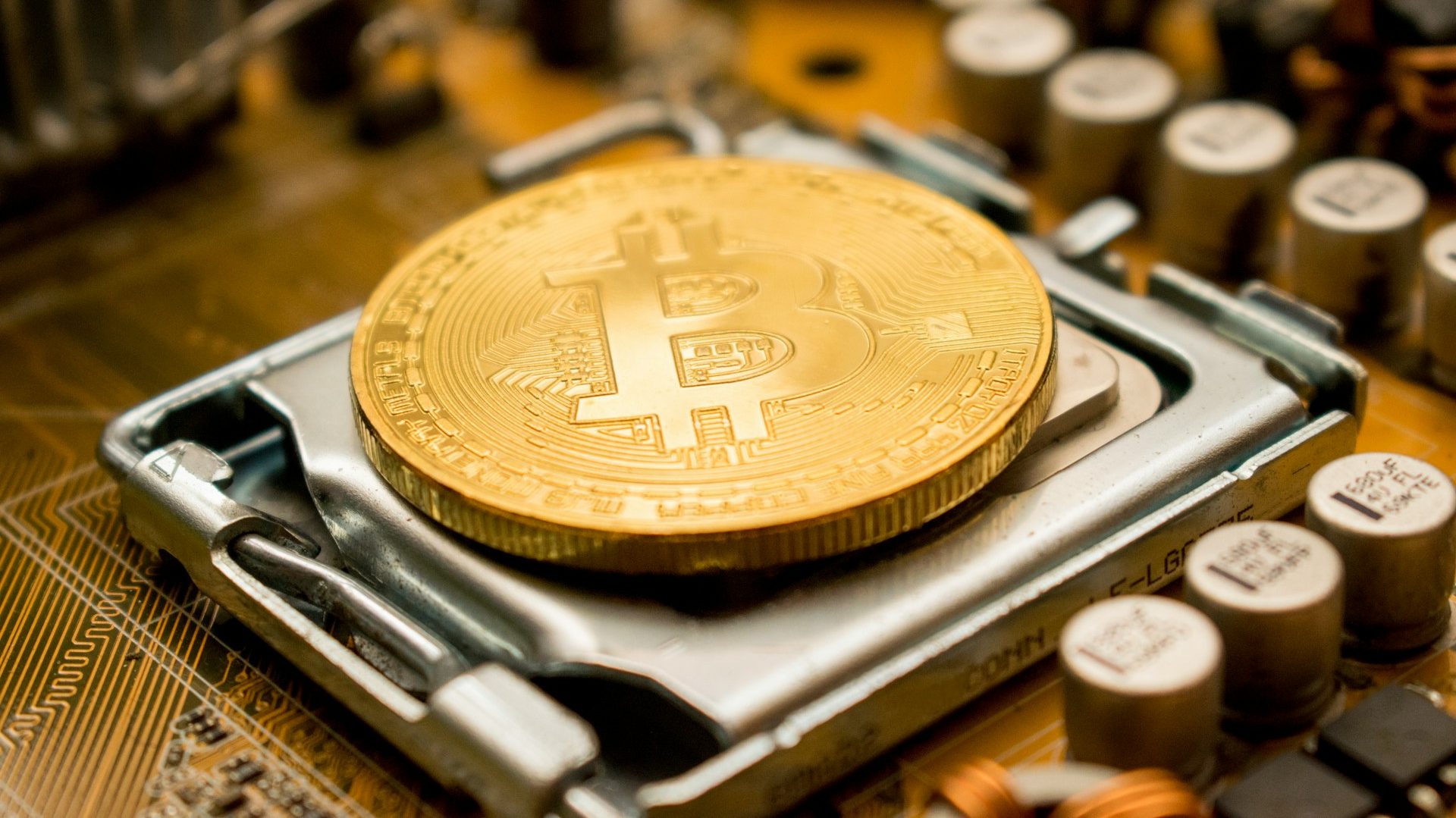 A close-up image of a Bitcoin coin placed on a computer processor, symbolizing the integration of cryptocurrency with digital technology, highlighting Pakistan’s step toward regulating digital assets.
