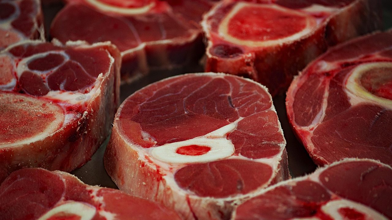 Close-up of raw beef shank cuts with exposed marrow bones, symbolizing the industrial scale of beef processing for export from India, despite cultural and religious restrictions on domestic beef consumption.