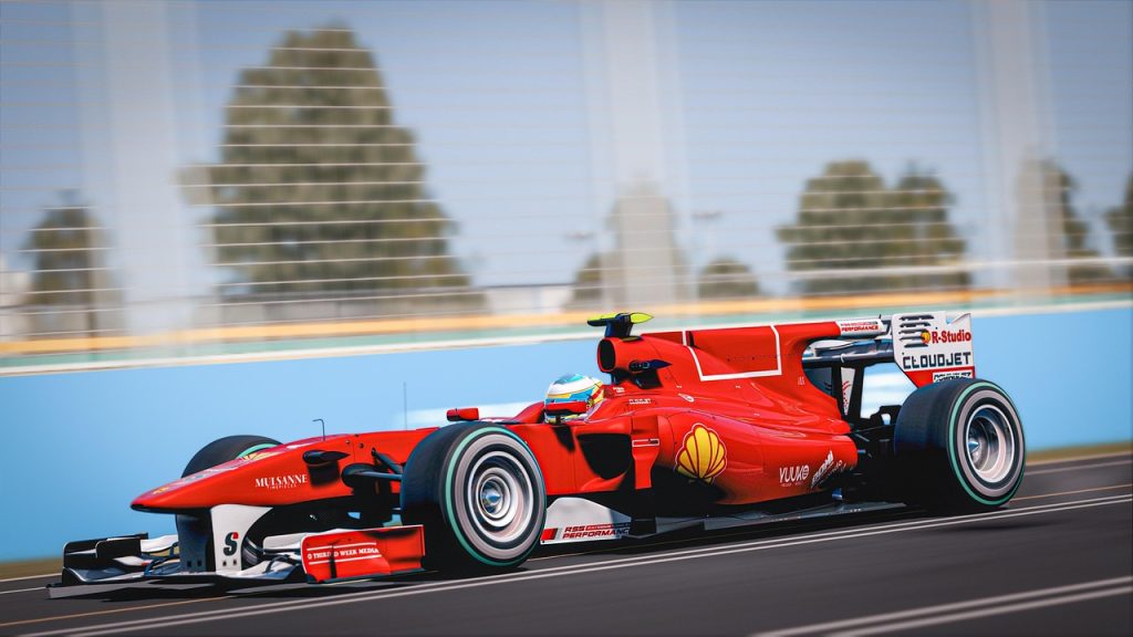A red Formula 1 car speeding on a racetrack, possibly referencing Apple’s interest in acquiring US F1 broadcast rights following a successful racing movie.