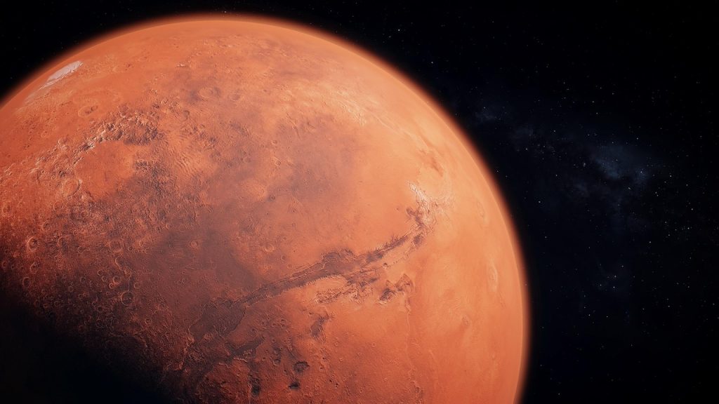Surface of Mars showing craters and canyons, hinting at past conditions explored by rovers in the search for life.