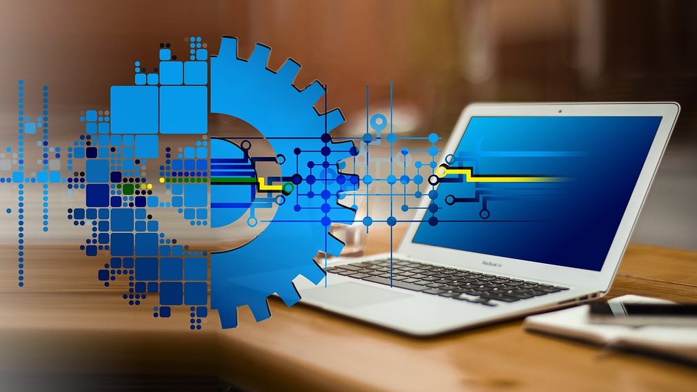 Illustration of digital gears and data flow graphics over a laptop, symbolizing the integration of technology and regulation, reflecting Pakistan’s move to establish a digital assets regulatory authority.